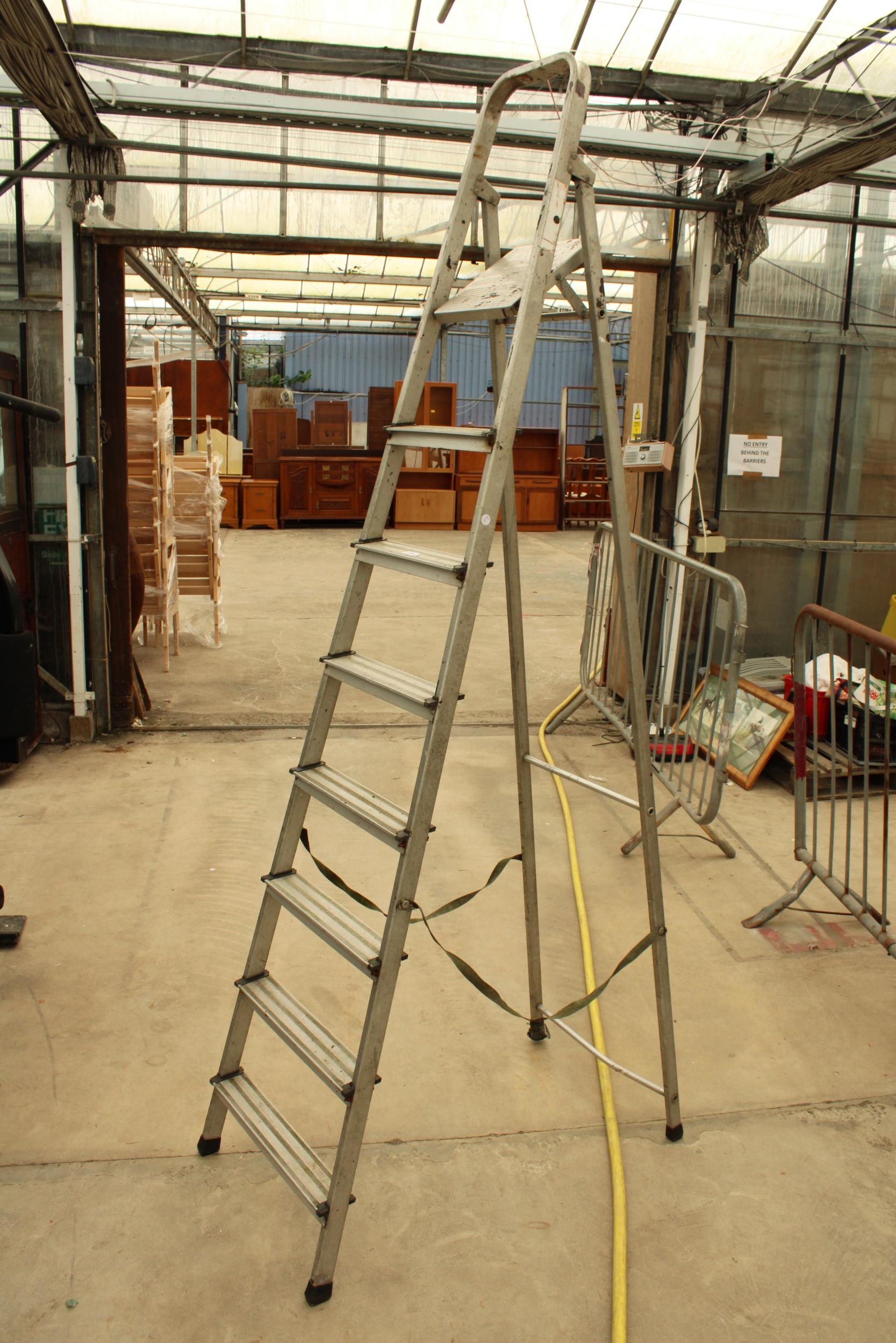 A SEVEN RUNG ALUMINIUM STEP LADDER
