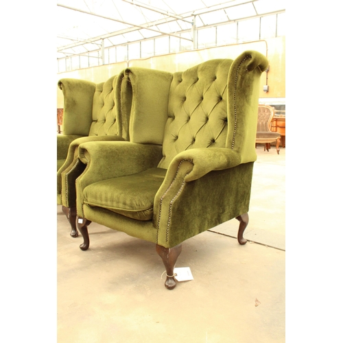 2889 - A PAIR OF GREEN BUTTON BACK WINGED FIRESIDE CHAIRS ON CABRIOLE LEGS AND STOOL