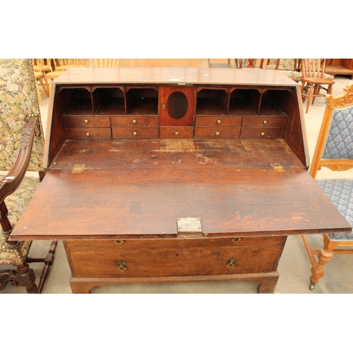 2903 - AN OAK GEORGE III BUREAU WITH FITTED INTERIOR, FOUR GRADUATED DRAWERS AND BRACKET FEET, 42.5