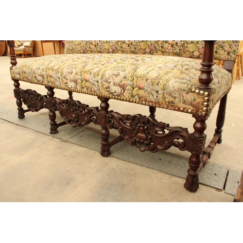 2904 - A CAROLEAN STYLE HEAVILY CARVED COUCH BY UNICORN UPHOLSTERY, 64