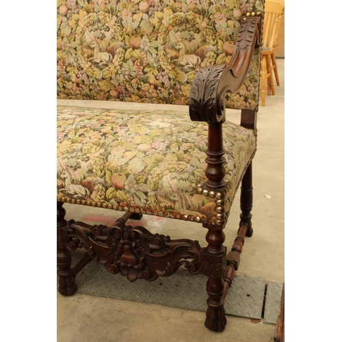 2904 - A CAROLEAN STYLE HEAVILY CARVED COUCH BY UNICORN UPHOLSTERY, 64