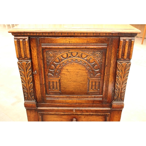 2910 - AN OAK GEORGIAN STYLE COCKTAIL CABINET WITH CARVED PANEL DOOR, SINGLE DRAWER AND SLIDE, ON OPEN BASE... 