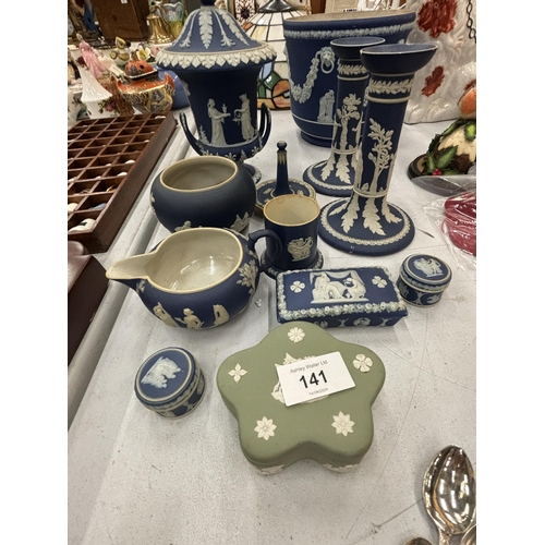 141 - A QUANTITY OF BLUE AND WHITE WEDGEWOOD TO INCLUDE A PAIR OF CANDLE STICKS, PLANTER, TRINKET BOXES ET... 