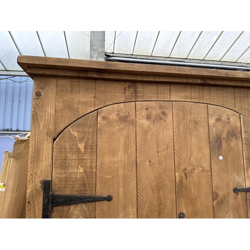 2948 - A HEAVY OAK CABINET WITH TWO DOORS AND SEVEN INNER SHELVES