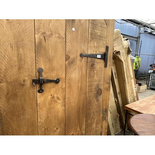 2948 - A HEAVY OAK CABINET WITH TWO DOORS AND SEVEN INNER SHELVES