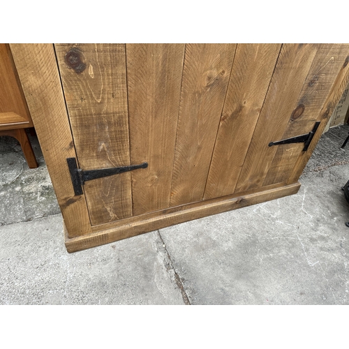 2948 - A HEAVY OAK CABINET WITH TWO DOORS AND SEVEN INNER SHELVES