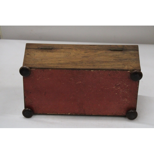 26 - A REGENCY ROSEWOOD SARCOPHAGUS SHAPED TEA CADDY WITH HINGED LID ON BUN FEET