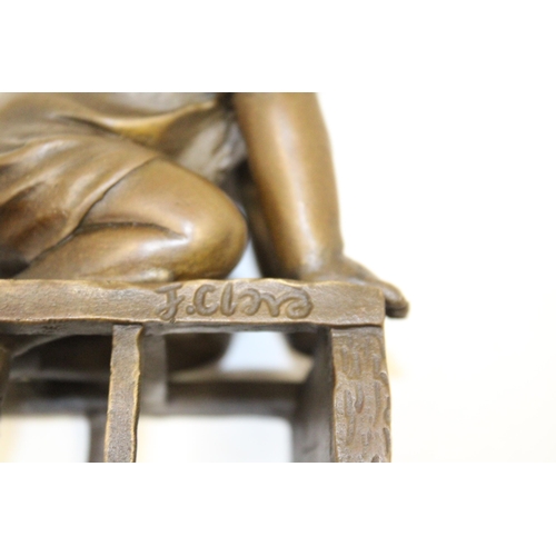 70 - A BRONZE FIGURE OF A CHILD ON A CHAIR - SIGNED