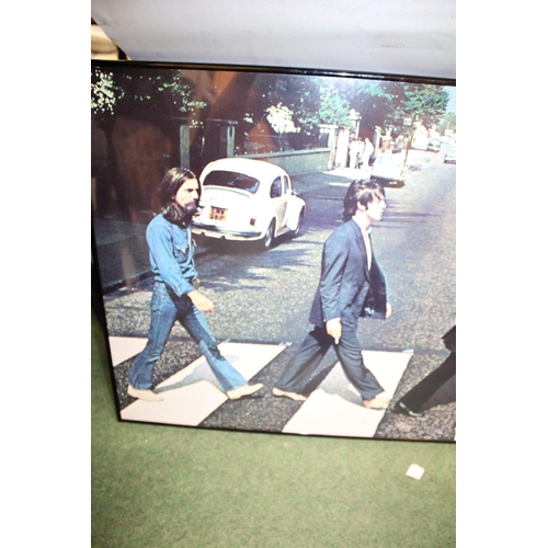 83 - A FRAMED POSTER OF THE BEATLES ABBEY ROAD - 84 X 51 CM