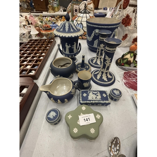 141 - A QUANTITY OF BLUE AND WHITE WEDGWOOD TO INCLUDE A PAIR OF CANDLE STICKS, PLANTER, TRINKET BOXES ETC... 