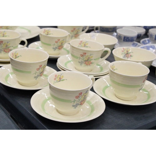 151 - A FLORAL TEA SET TO INCLUDE SEVEN CUPS AND SAUCERS, TWO SUGAR BOWLS, GRAVY JUG ETC