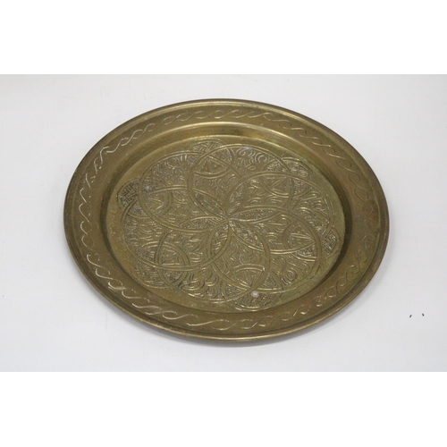 163 - A BRASS ARTS AND CRAFTS STYLE WALL PLAQUE, DIAMETER  25CM