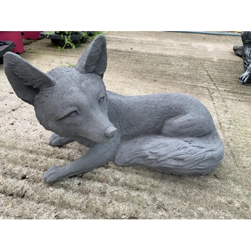 66 - ONE FOX LYING DOWN CONCRETE GARDEN ORNAMENT APPROX 38CM IN LENGTH PLUS VAT