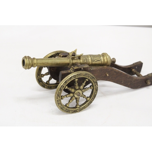 207 - A WOOD AND BRASS CANNON