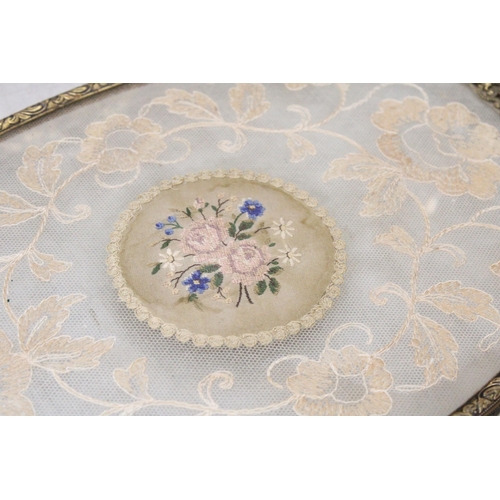 221 - A PETIT POINT EMBROIDERED DRESSING TABLE TRAY WITH A PAIR OF BRASS CANDLESTICKS