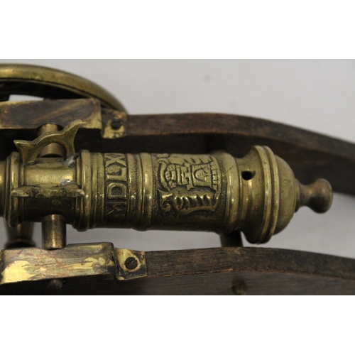 207 - A WOOD AND BRASS CANNON