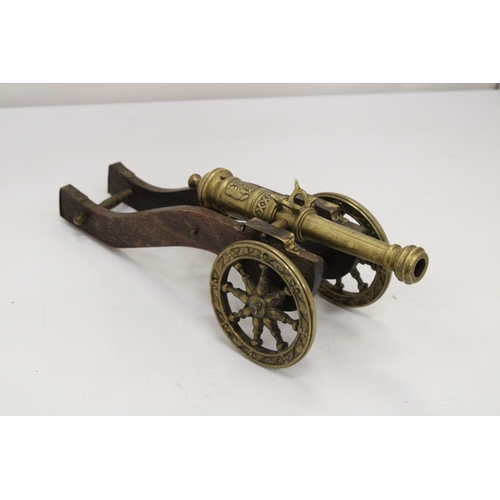 207 - A WOOD AND BRASS CANNON