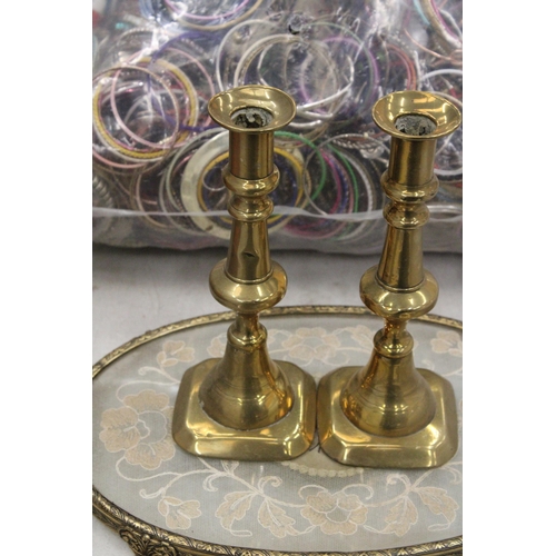 221 - A PETIT POINT EMBROIDERED DRESSING TABLE TRAY WITH A PAIR OF BRASS CANDLESTICKS