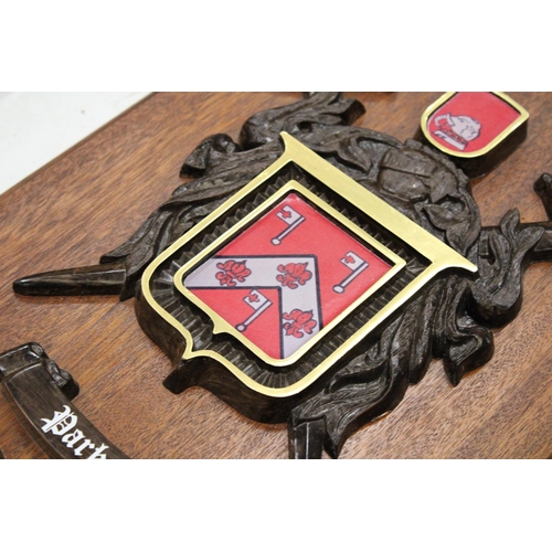 248 - A MAHOGANY SHIELD WITH A COAT OF ARMS FOR 'PARKER', 25CM X 32CM