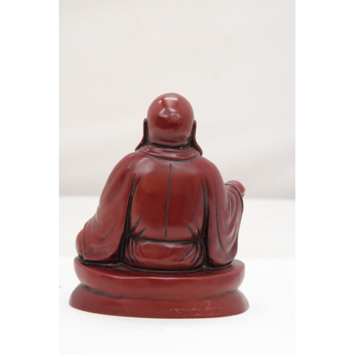 253 - A FIGURE OF A LAUGHING RED BUDDAH