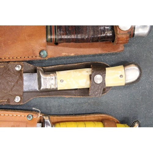 265 - THREE VINTAGE DAGGERS IN LEATHER SHEATHS