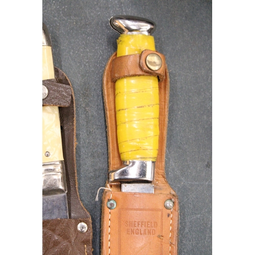 265 - THREE VINTAGE DAGGERS IN LEATHER SHEATHS