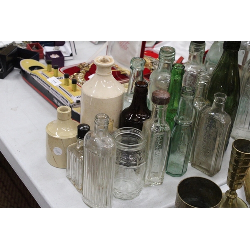 314 - A LARGE COLLECTION OF VINTAGE GLASS AND STONEWARE BOTTLES