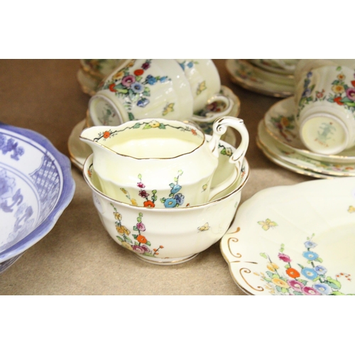 384 - A VINTAGE CROWN STAFFORDSHIRE TEASET IN PALE YELLOW WITH FLORAL DECORATION TO INCLUDE, A CAKE PLATE,... 