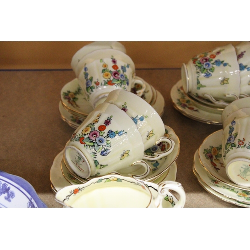 384 - A VINTAGE CROWN STAFFORDSHIRE TEASET IN PALE YELLOW WITH FLORAL DECORATION TO INCLUDE, A CAKE PLATE,... 