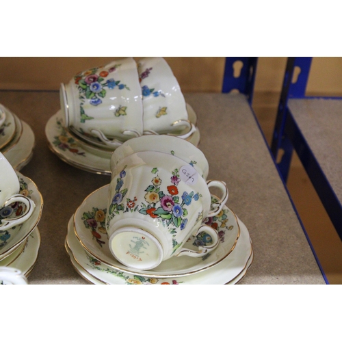 384 - A VINTAGE CROWN STAFFORDSHIRE TEASET IN PALE YELLOW WITH FLORAL DECORATION TO INCLUDE, A CAKE PLATE,... 