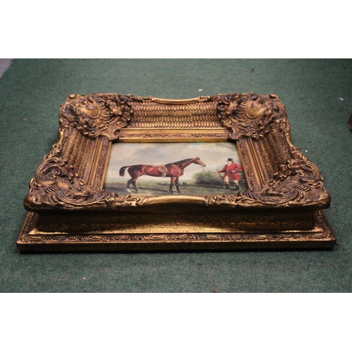 52 - A PRINT ON BOARD OF AN UNMOUNTED HUNTSMAN AND HORSE IN A HEAVY GILT FRAME - FRAMED BY CARVERS AND GI... 