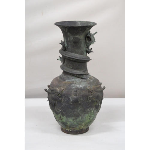 7 - A CHINESE BRASS RAISED BALUSTER VASE WITH FIGURAL MYTHICAL SCROLLING DRAGONS CHASING A FLAMING PEARL... 