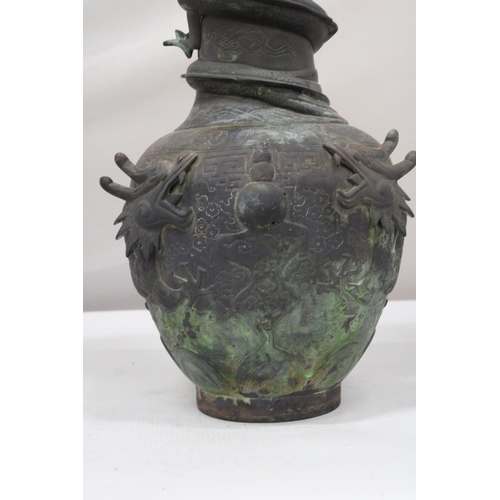 7 - A CHINESE BRASS RAISED BALUSTER VASE WITH FIGURAL MYTHICAL SCROLLING DRAGONS CHASING A FLAMING PEARL... 