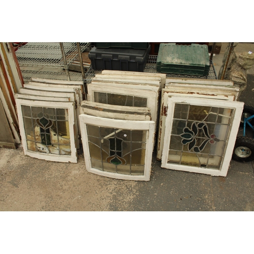 A LARGE ASSORTMENT OF WOODEN FRAMED STAIN GLASS WINDOWS