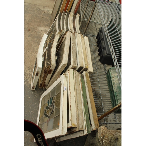 A LARGE ASSORTMENT OF WOODEN FRAMED STAIN GLASS WINDOWS
