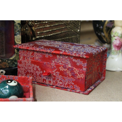 395 - TWO ORIENTAL STYLE JEWELLERY BOXES PLUS A BOXED SET OF TWO ORIENTAL STRESS BALLS