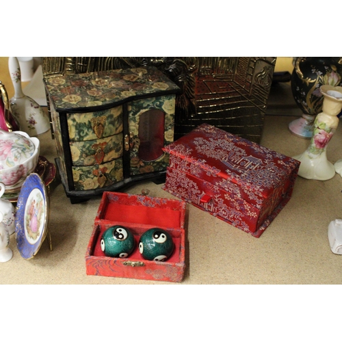 395 - TWO ORIENTAL STYLE JEWELLERY BOXES PLUS A BOXED SET OF TWO ORIENTAL STRESS BALLS