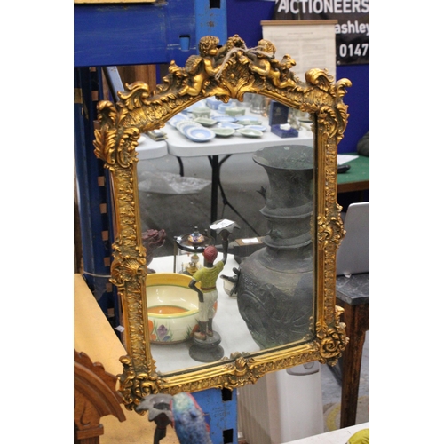 75 - AN ORNATE GILTWOOD MIRROR WITH CHERUB DETAIL