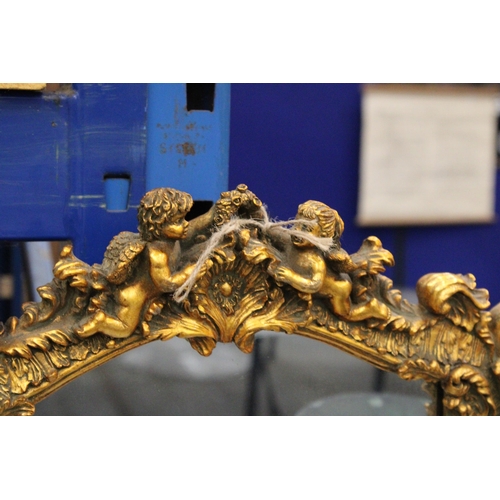 75 - AN ORNATE GILTWOOD MIRROR WITH CHERUB DETAIL