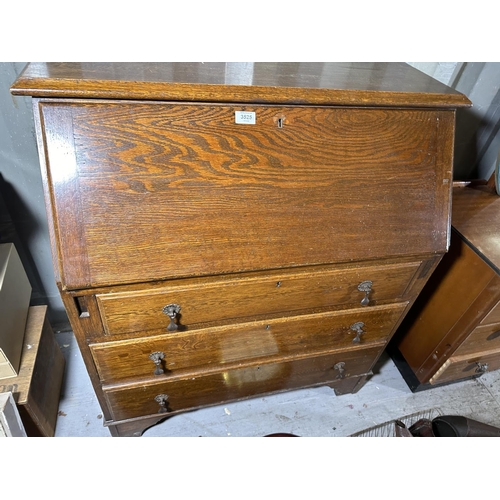 3525 - AN OAK BUREAU WITH FITTED INTERIOR AND THREE LOWER DRAWERS