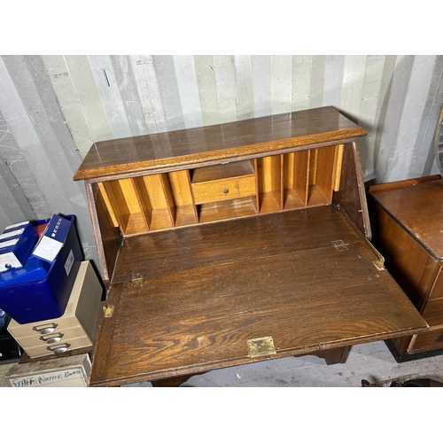 3525 - AN OAK BUREAU WITH FITTED INTERIOR AND THREE LOWER DRAWERS