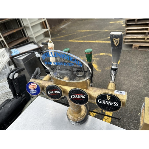 3530 - A BRASS FOUR BRANCH BEER TAP WITH CARLING, TETLEYS AND GUINNESS FRONTS