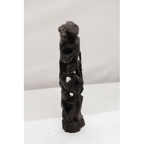 252 - AN AFRICAN HAND CARVED TREE OF LIFE FIGURE, HEIGHT 29CM