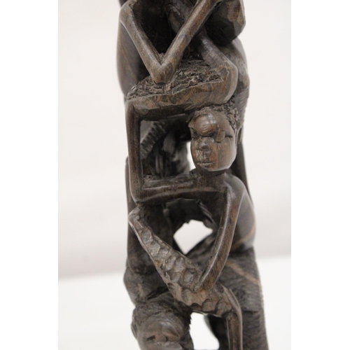 252 - AN AFRICAN HAND CARVED TREE OF LIFE FIGURE, HEIGHT 29CM