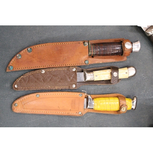 265 - THREE VINTAGE DAGGERS IN LEATHER SHEATHS