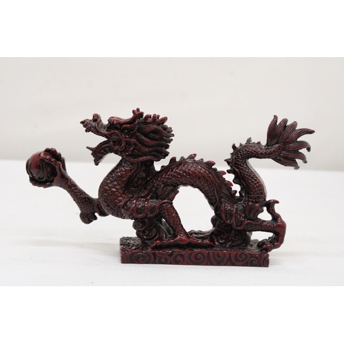 289 - A RED RESIN ORIENTAL DRAGON, HEIGHT 12CM, LENGTH 23CM