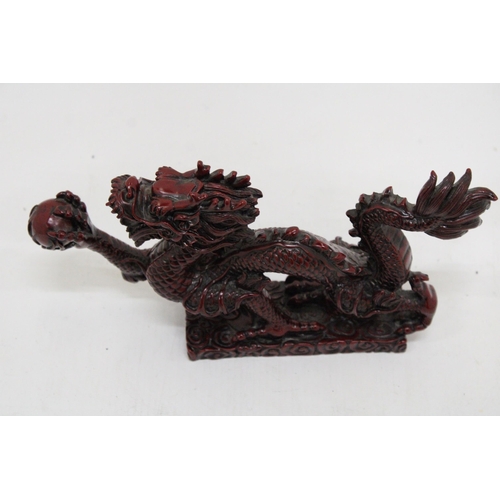 289 - A RED RESIN ORIENTAL DRAGON, HEIGHT 12CM, LENGTH 23CM