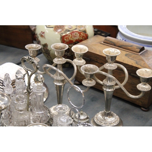 291 - A LARGE QUANTITY OF SILVER PLATED ITEMS TO INCLUDE TRAYS, CANDLEABRAS, TWO CONDIMENT SETS WITH GLASS... 