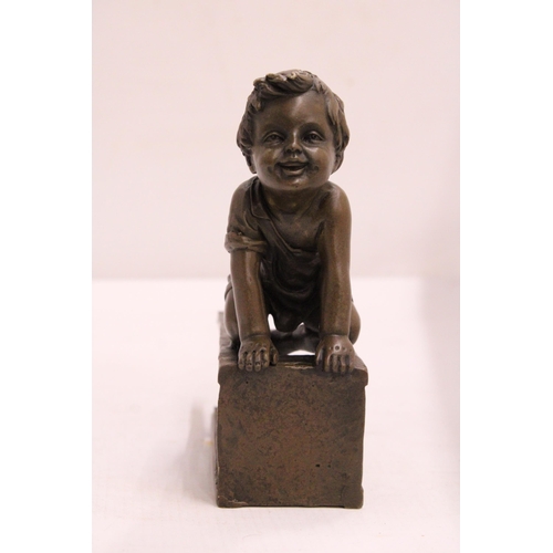 333 - A BRONZE FIGURE OF A CHILD ON A CHAIR - SIGNED