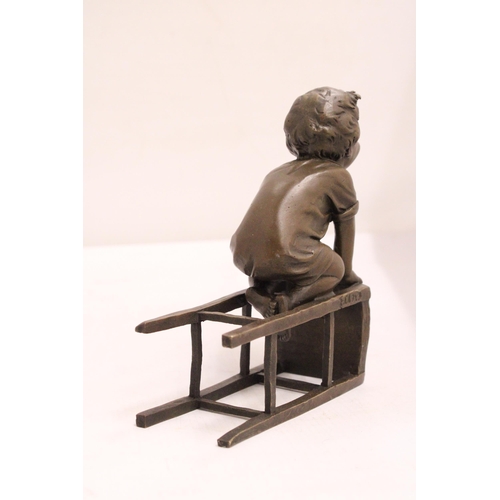 333 - A BRONZE FIGURE OF A CHILD ON A CHAIR - SIGNED